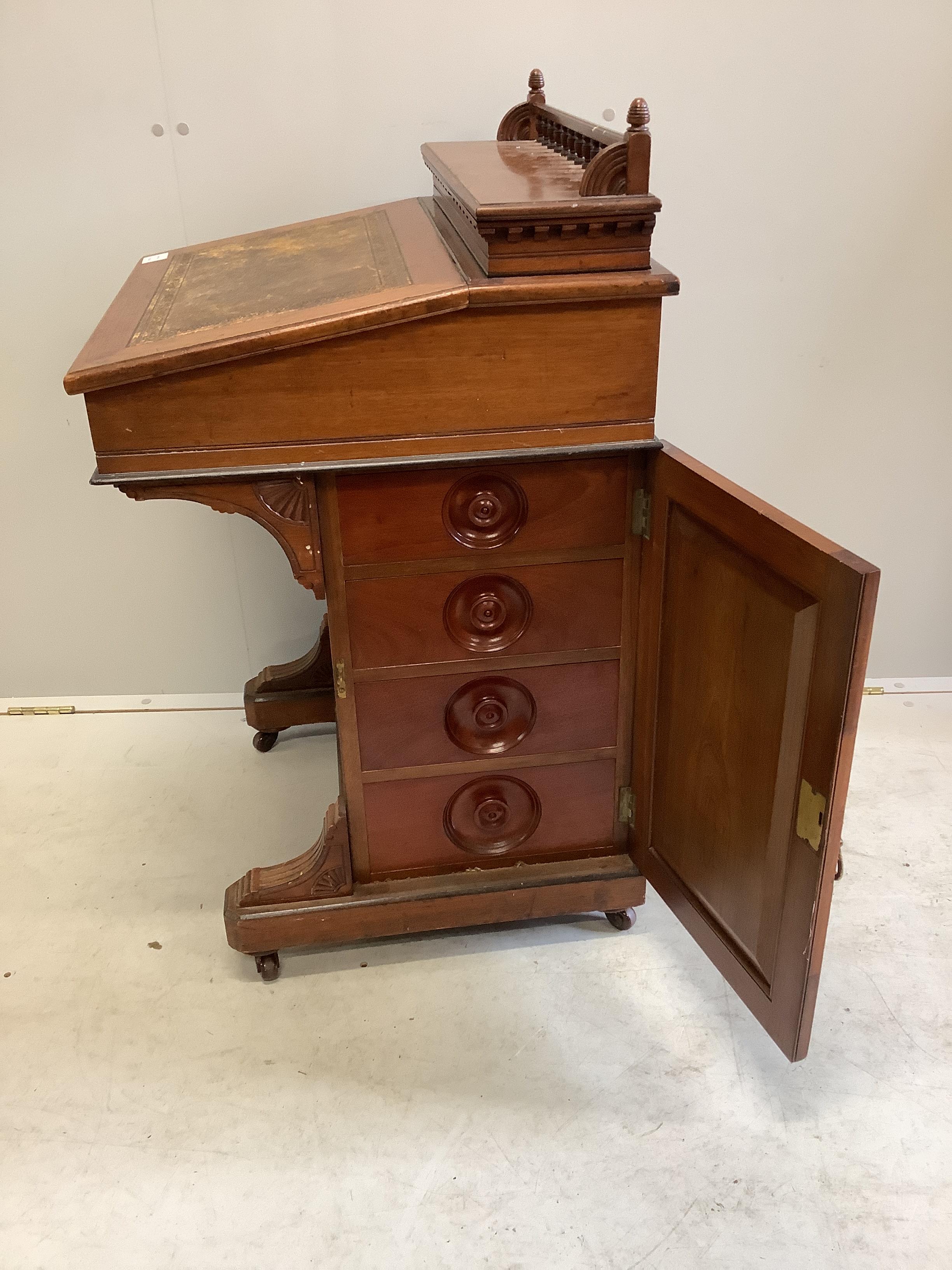 A late Victorian Aesthetic movement mahogany davenport by Jas. Shoolbred & Co., width 56cm, depth 56cm, height 94cm